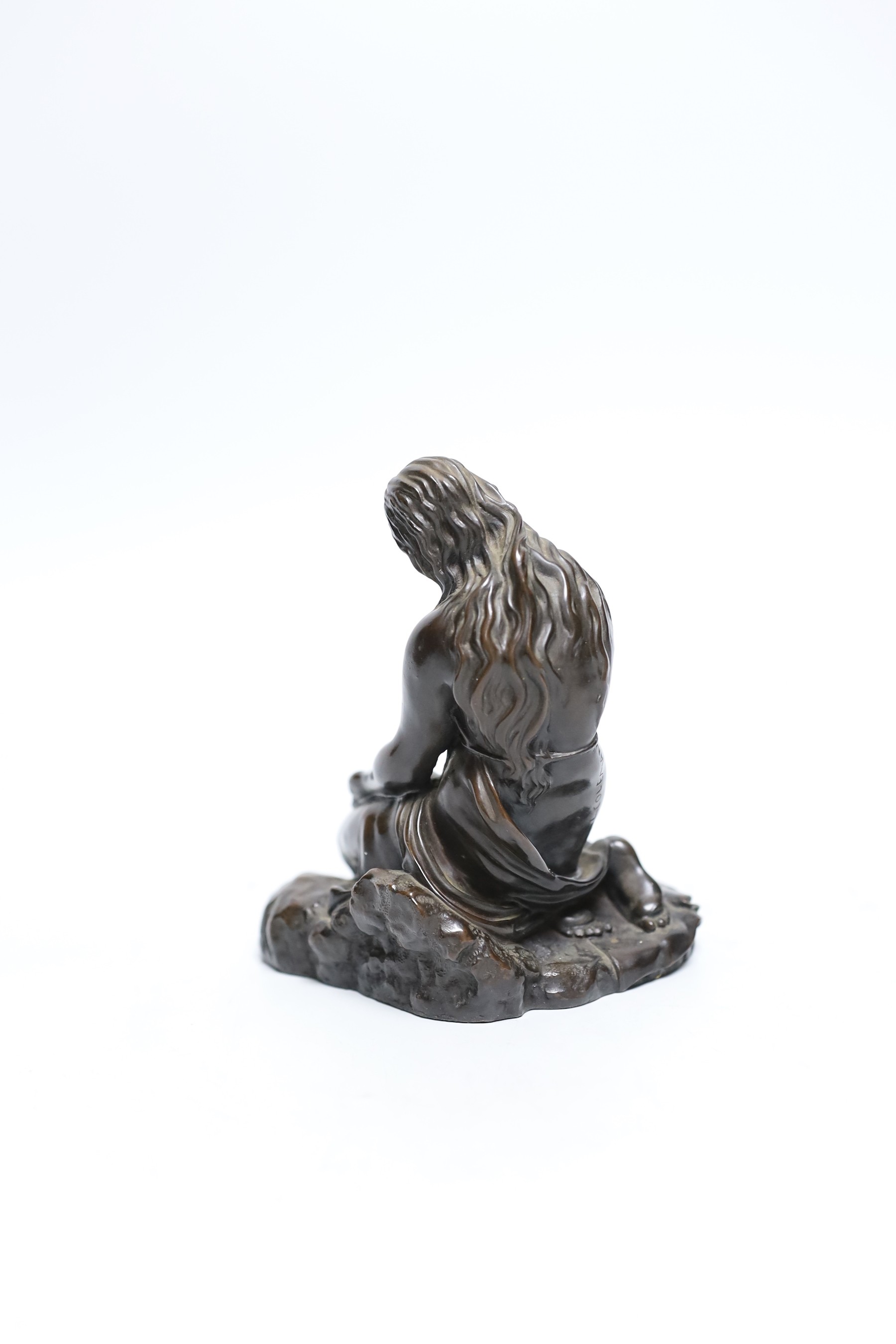 A cast resin figure of a kneeling classical figure, 13.5cms high